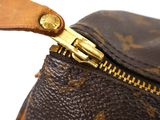 the zipper of a louis vuitton handbag with a gold zipper