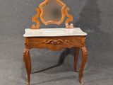 an antique wooden vanity with a marble top and mirror