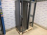 a large metal rack in a warehouse with a sign on the wall behind it