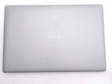 dell laptop computer sitting on top of a white surface with a dell logo on the screen