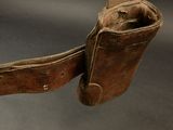 a brown leather belt with a leather sheath attached to it