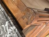 a wooden clock that is sitting on a table
