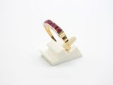 a close up of a gold ring with a ruby stone in it