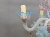 a glass chandelier with a pink and blue design on it