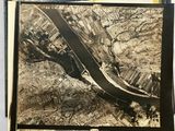 an old black and white photo of a river running through a city
