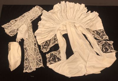 a black table with a black cloth and white lace on it