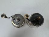 a silver cup with a handle and a spoon on it