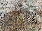 a very old carpet with many different designs on it