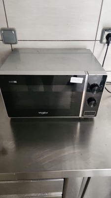 a microwave sitting on top of a stainless steel counter