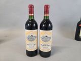 two bottles of wine sitting next to each other on a table