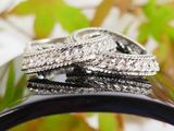 two wedding rings sitting on top of each other on a table