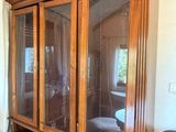 un grand meuble en bois avec des portes en verre dans une pièce