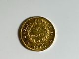 a gold coin on a white surface with a white background