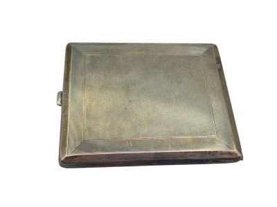 an antique silver cigarette case with a metal cover