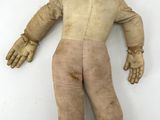 a small doll with a hat and boots on a white surface