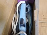 a purple box with a blue and white steam iron in it