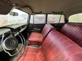an old car with red leather seats and a steering wheel