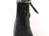 a close up of a black purse on a white background