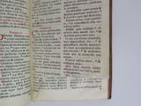 an open book with red writing on it sitting on a table
