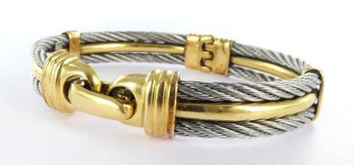a close up of a bracelet on a white surface