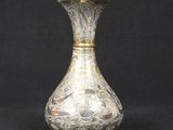 a silver vase on a black background with a black background