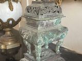 a statue that is sitting on a table with a mirror in the background