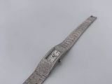 a close up of a watch on a white surface with a white background