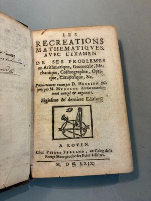 an old book with writing on it sitting on top of a table