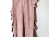 the back of a pink dress hanging on a hanger