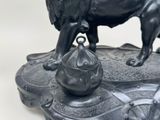 a statue of a lion that is standing on a table