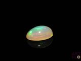 an image of a white oplite in the dark