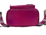 a pink bag that is sitting on a white surface