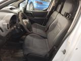the interior of a car with the door open and the driver ' s seat down