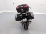 a motorcycle parked in a room with a license plate on the back of it