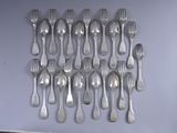 a lot of forks and spoons hanging on the wall