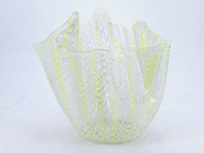 a glass vase that is sitting on a white surface
