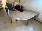 a table with a computer on it in a room