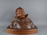 statue of a man with a hat on a wooden base