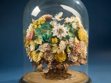 a glass clochet with a bunch of flowers inside of it