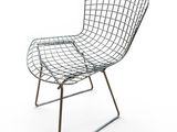 a black wire chair sitting on top of a metal frame