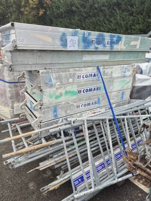 a pile of junk on the ground next to a dumpster
