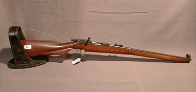 un vieux fusil avec un canon en bois et un étui en cuir