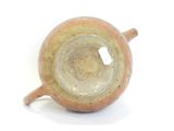 a brown cup with a handle sitting on a white surface