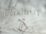 a close up of a statue of a person with a compass on it