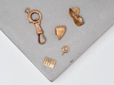 some gold pieces on a table with a key