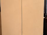 a refrigerator that is sitting in the corner of the room