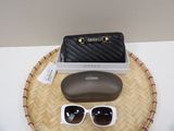 a pair of sunglasses and a case sitting on a tray