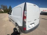 the rear end of a white van parked in a parking lot