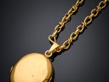 an image of a gold locke with a chain on a black background