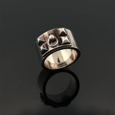 a close up of a silver ring with a cross on it